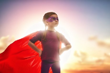 Little girl pretending to be a superhero