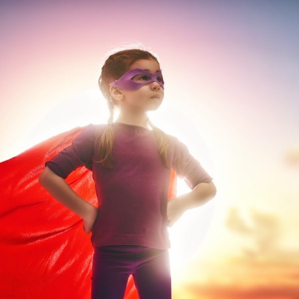 Little girl pretending to be a superhero